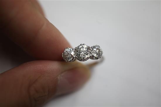 A mid 20th century white gold and three stone diamond ring, size closed, K.